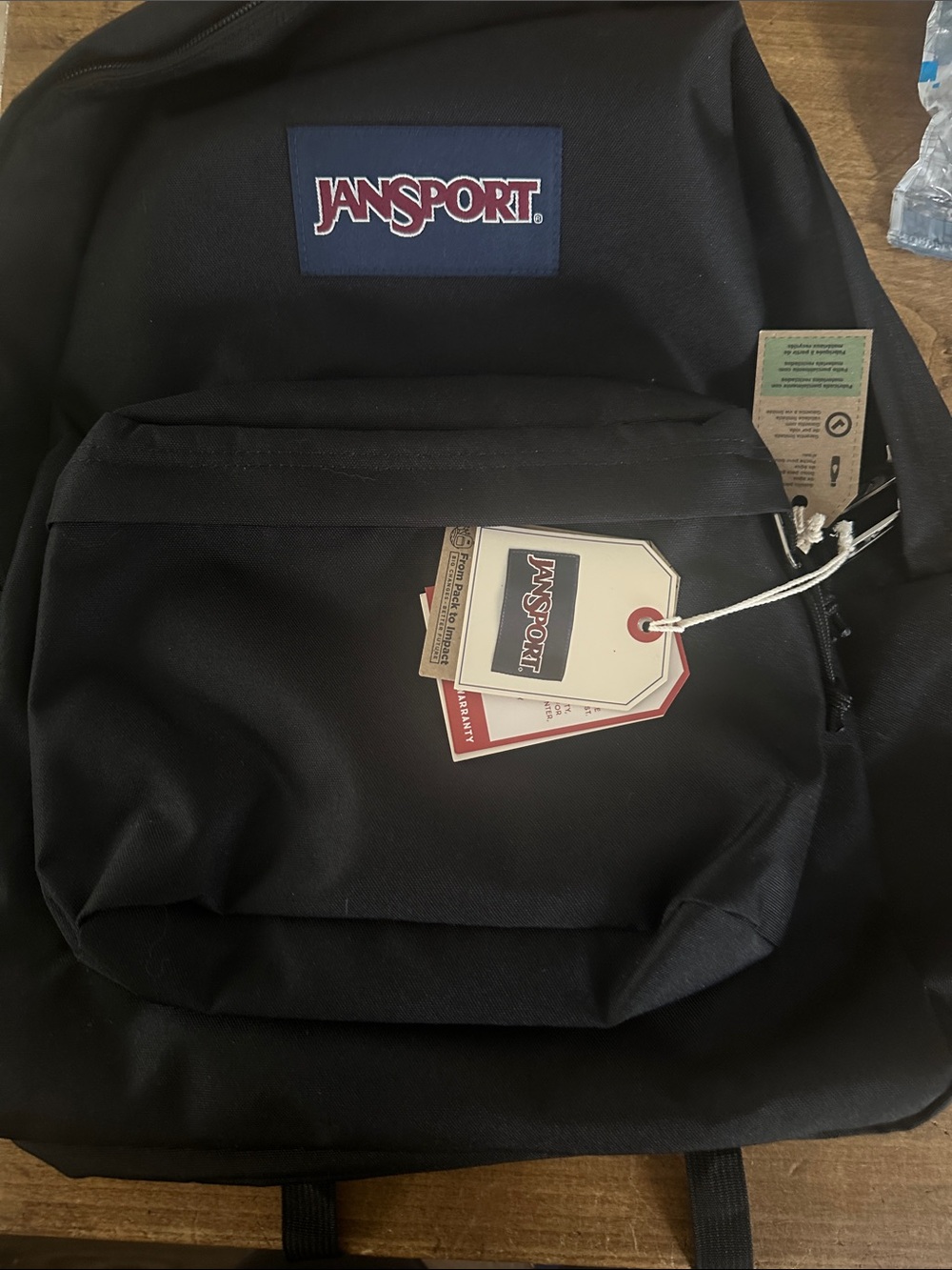 Jansport Black Backpack with Red and White Logo Patch